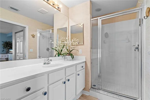 a bathroom with a shower sink and mirror