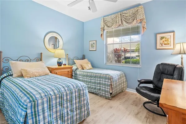 a bedroom with two beds and a window