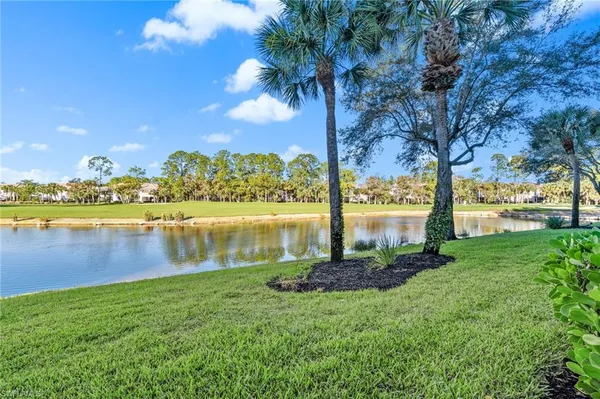a view of a lake with houses in the back