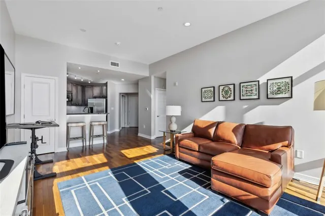 a living room with furniture and kitchen view