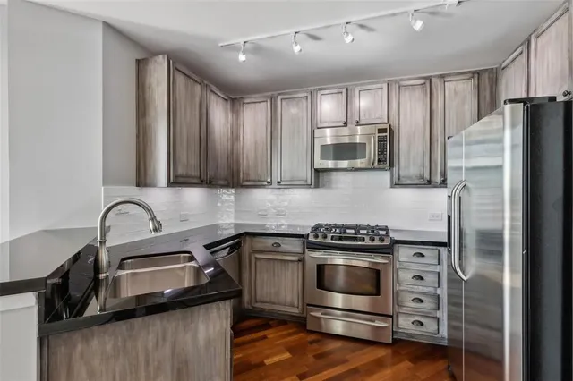 a kitchen with a sink stove and refrigerator