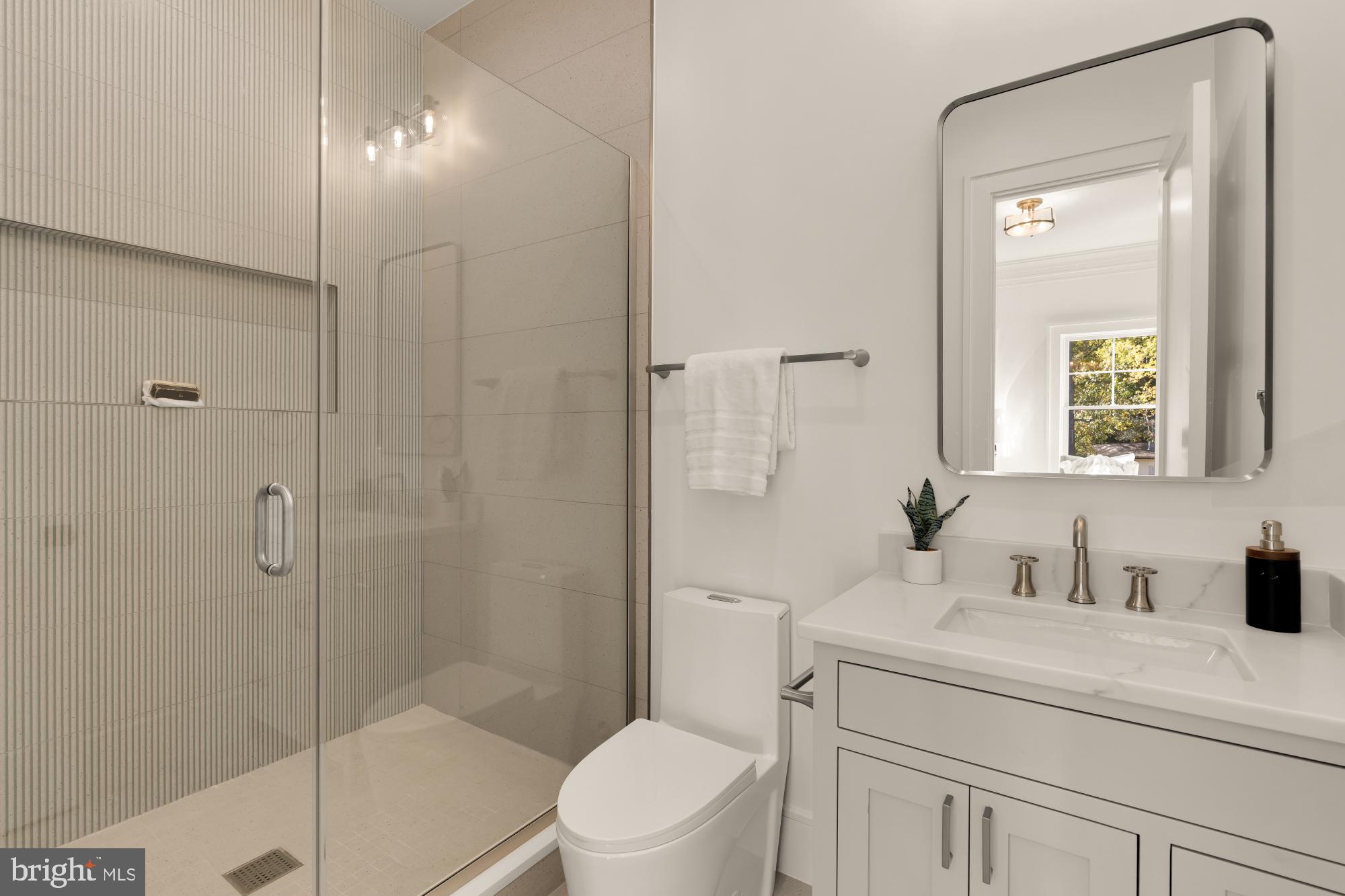 9105 Seven Locks Road Bethesda, MD 20817 - Photo 23 of 84 a bathroom with a sink a toilet and shower