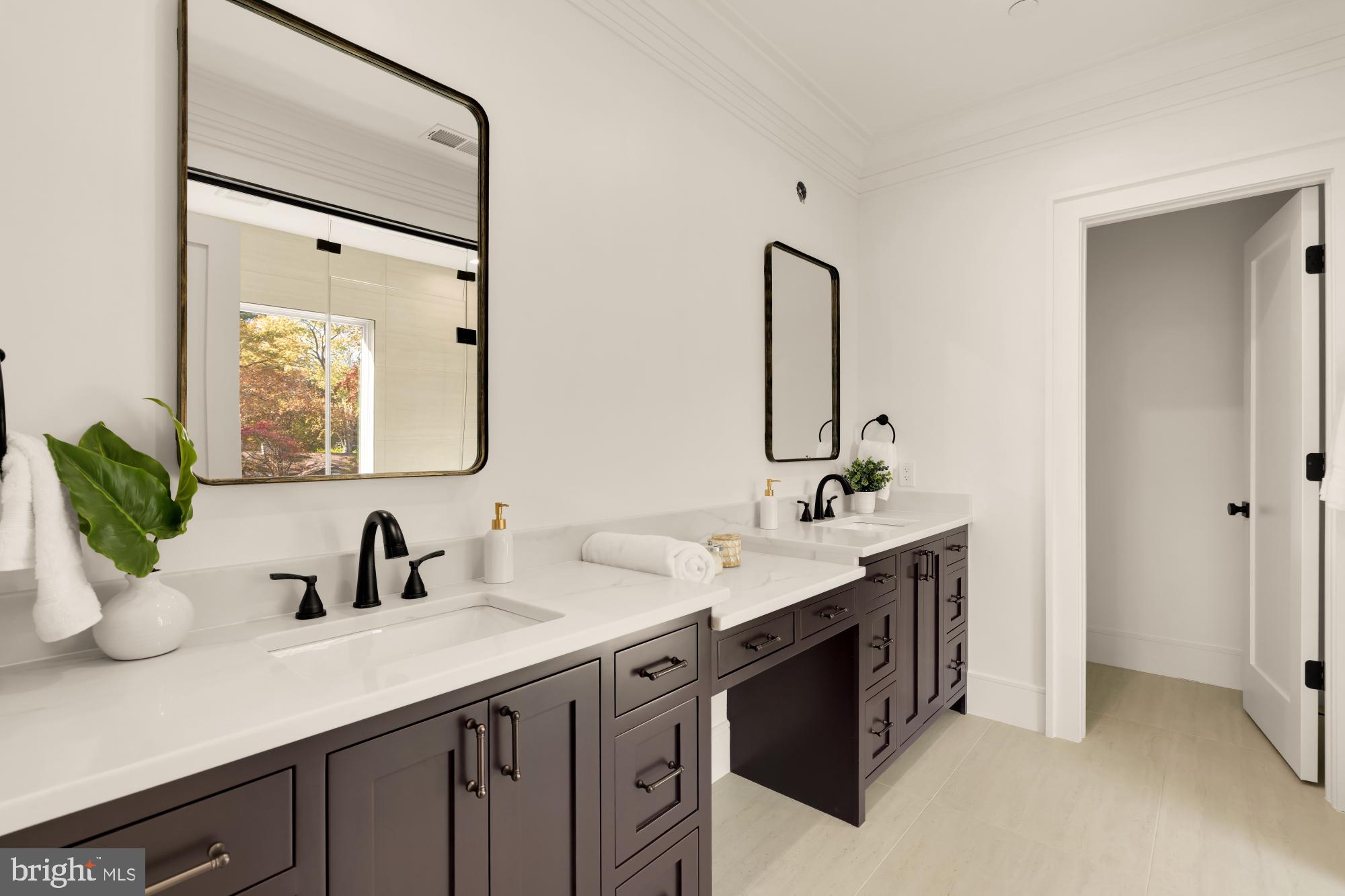 9105 Seven Locks Road Bethesda, MD 20817 - Photo 40 of 84 a bathroom with a double vanity sink mirror and