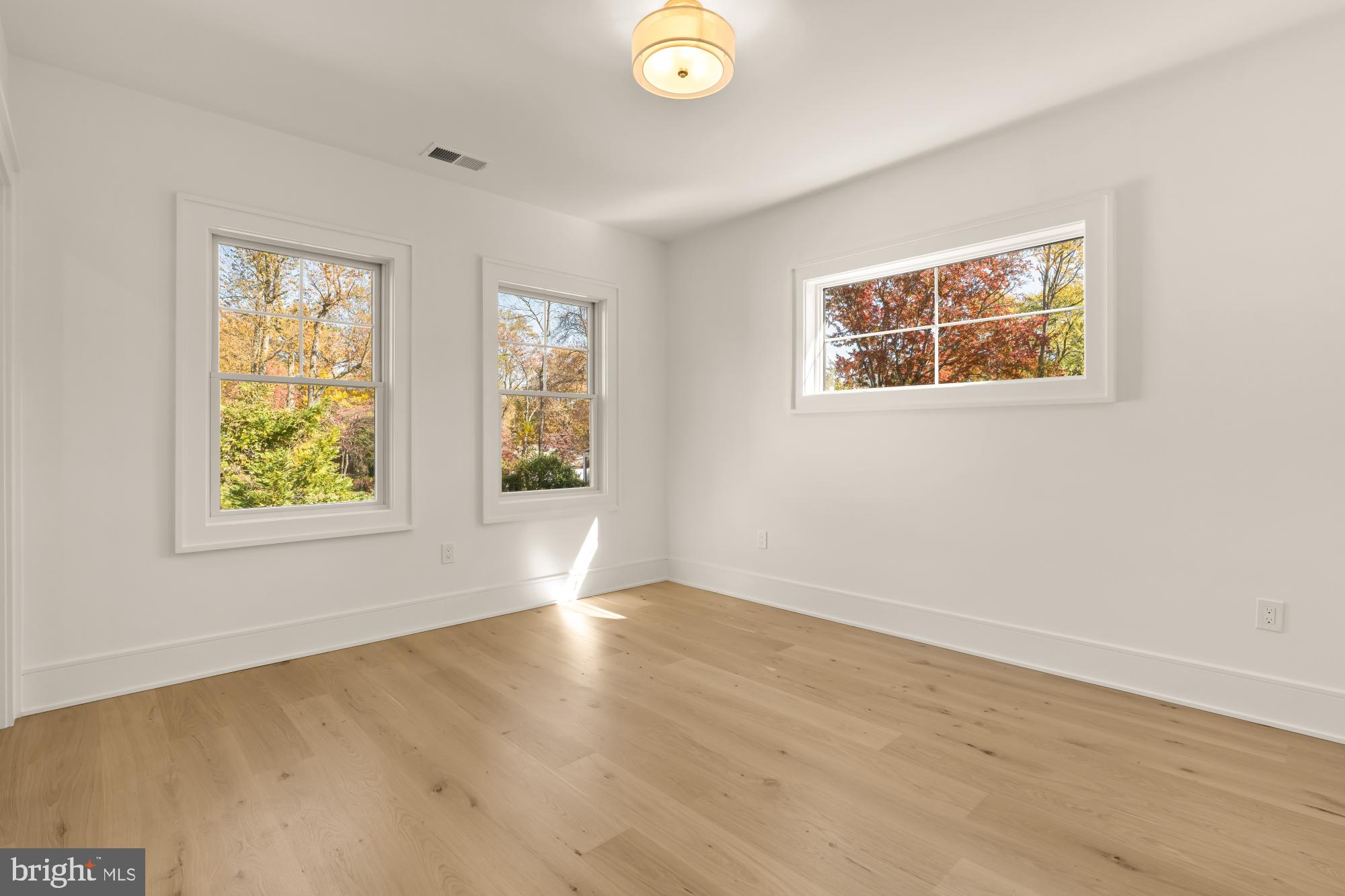 9105 Seven Locks Road Bethesda, MD 20817 - Photo 45 of 84 a view of an empty room with wooden floor and window