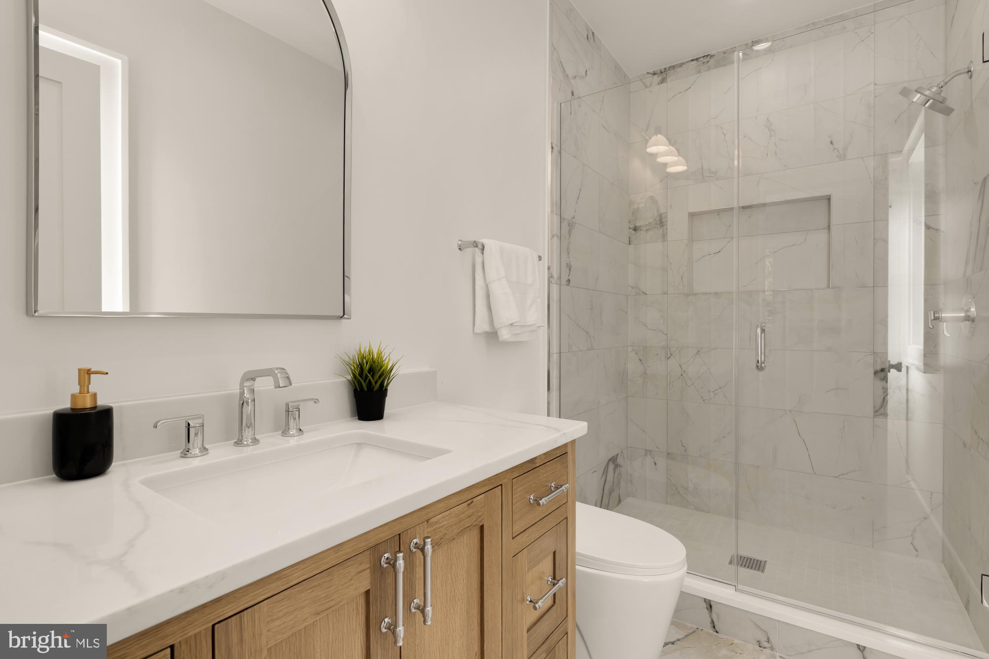 9105 Seven Locks Road Bethesda, MD 20817 - Photo 54 of 84 a bathroom with a sink a toilet and shower