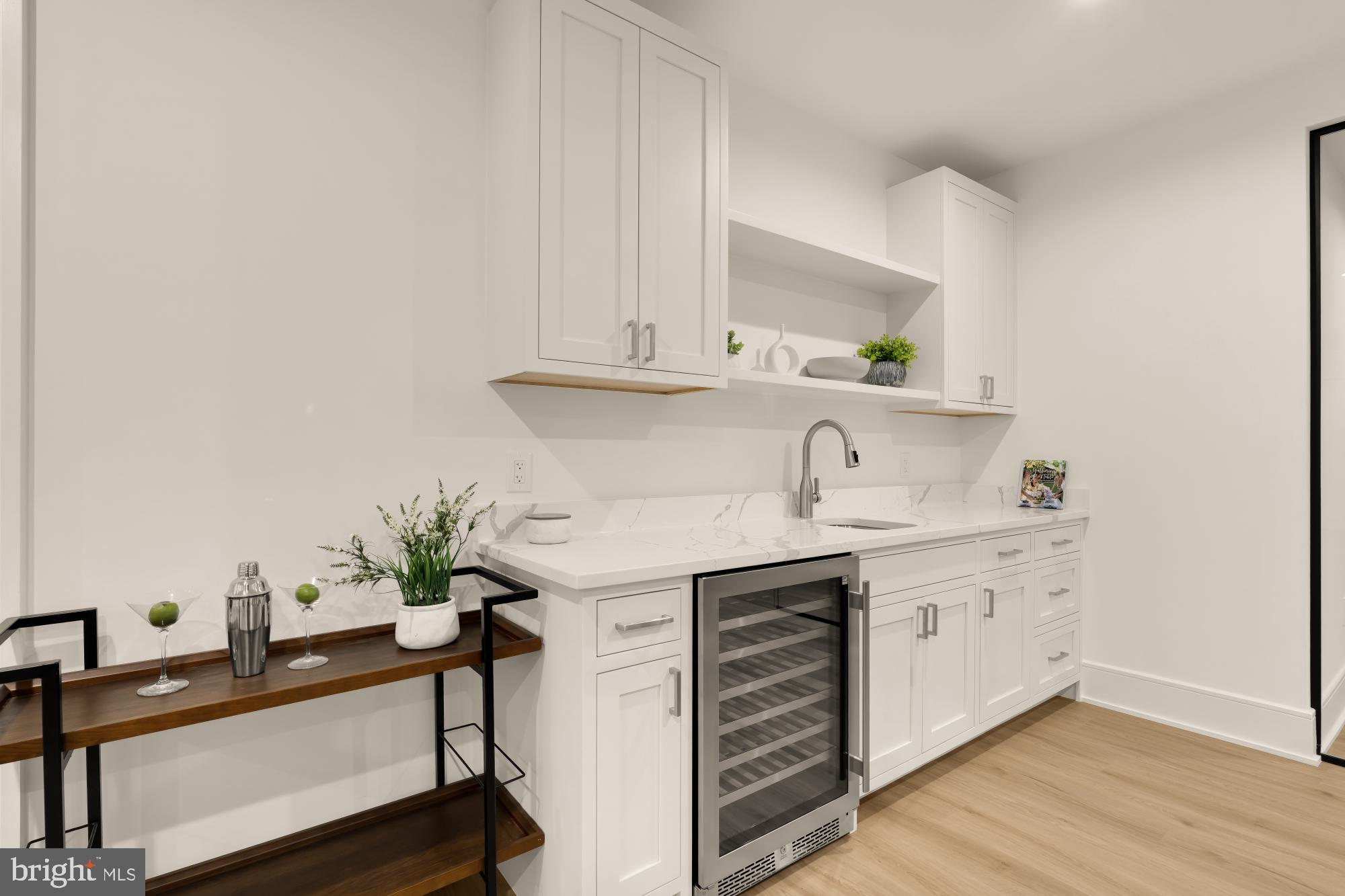 9105 Seven Locks Road Bethesda, MD 20817 - Photo 60 of 84 a view of cabinets a sink and a stove with wooden floor