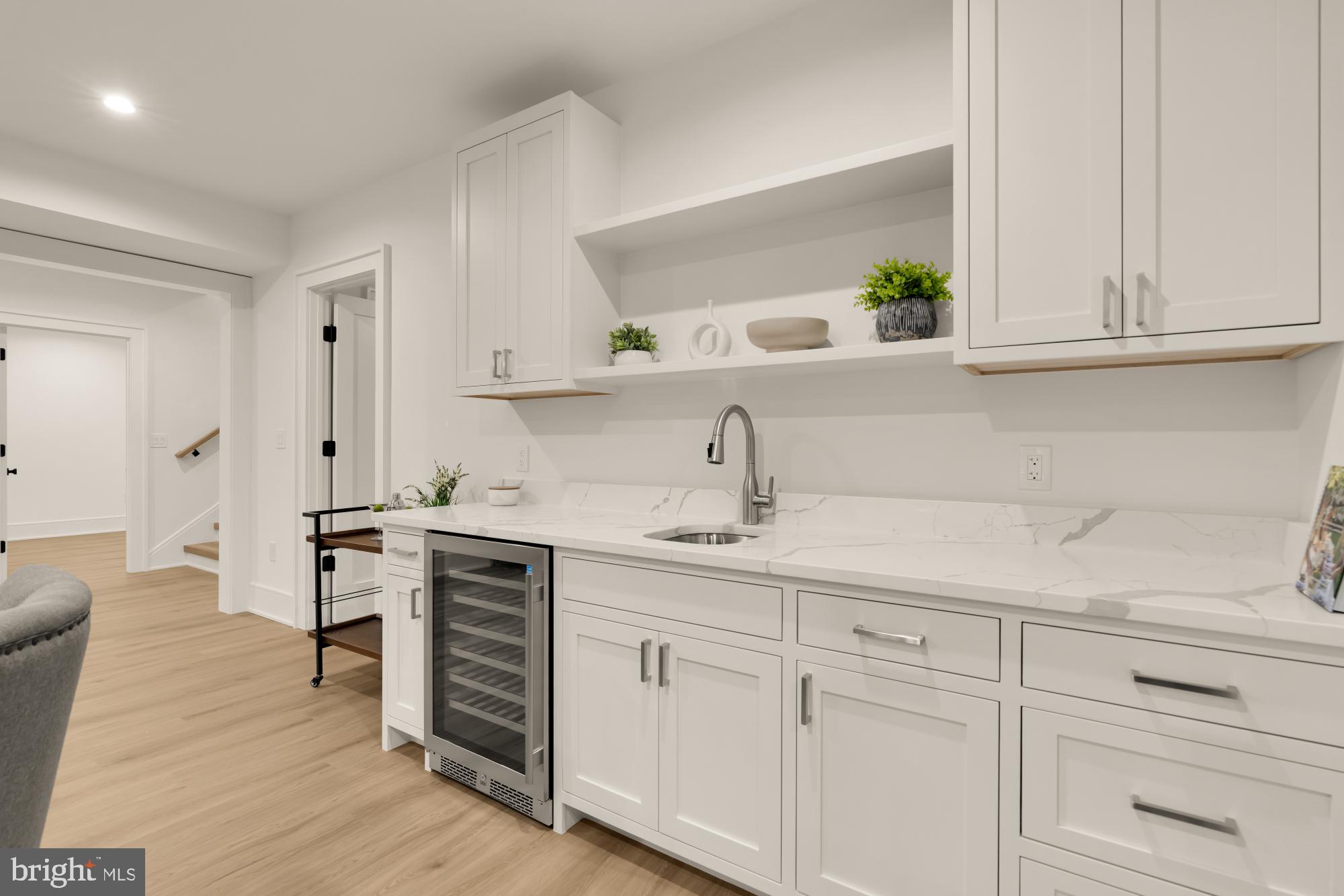 9105 Seven Locks Road Bethesda, MD 20817 - Photo 62 of 84 a kitchen with stainless steel appliances white cabinets and a wooden floors