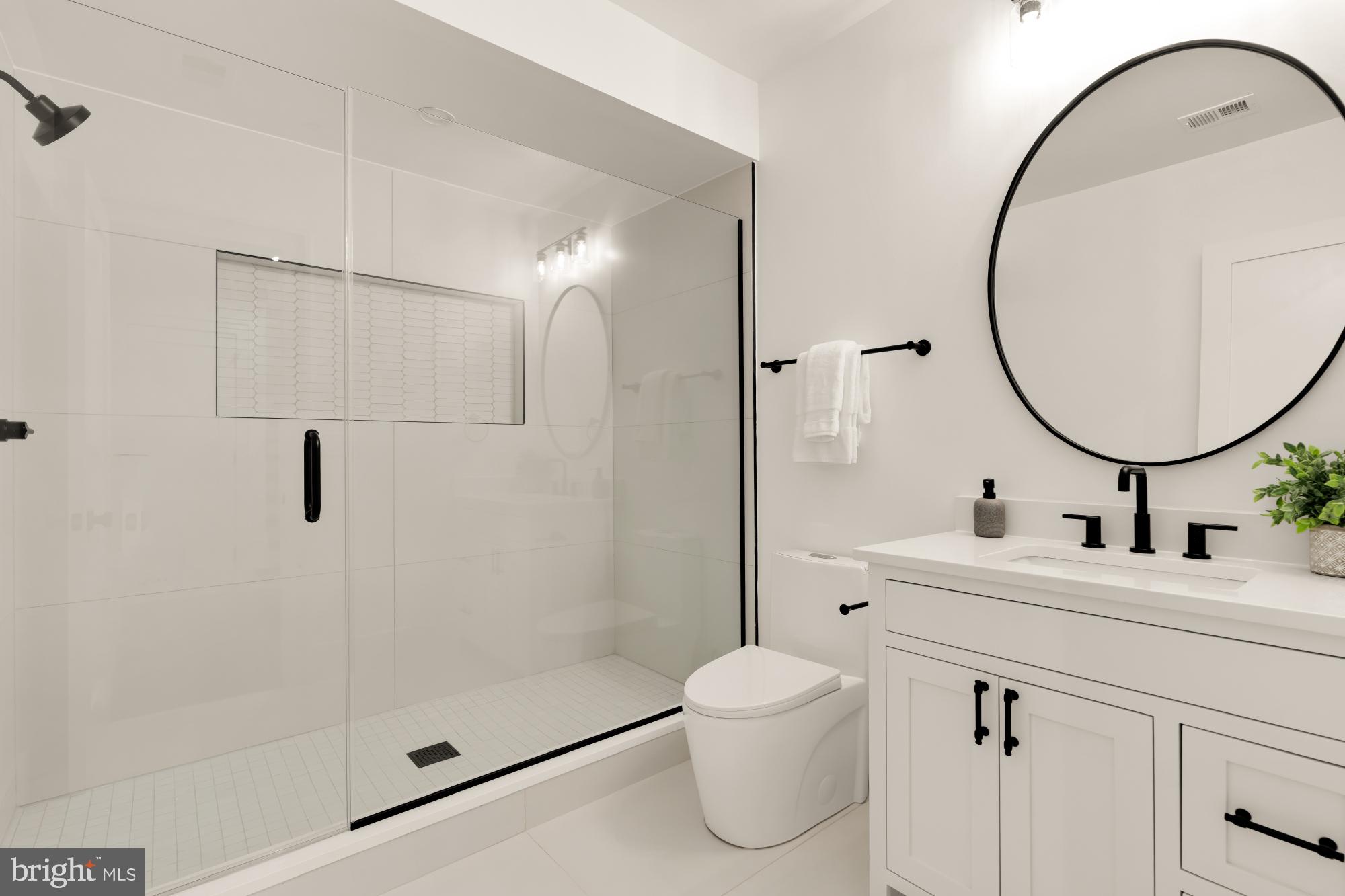 9105 Seven Locks Road Bethesda, MD 20817 - Photo 72 of 84 a bathroom with a sink toilet and shower