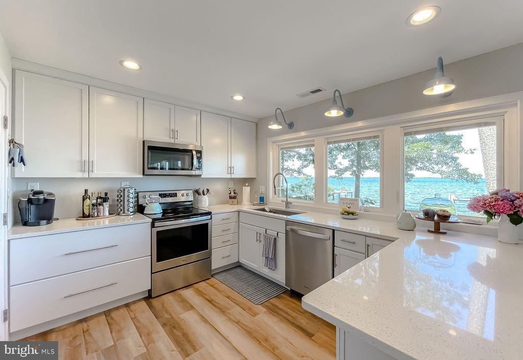 18375 River Road Tall Timbers, MD 20690 - Photo 15 of 61 a kitchen with a sink stove and cabinets