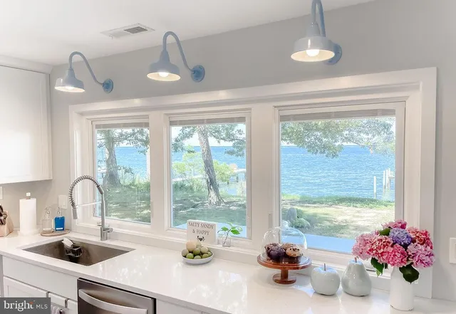 a kitchen with a large window and cabinets