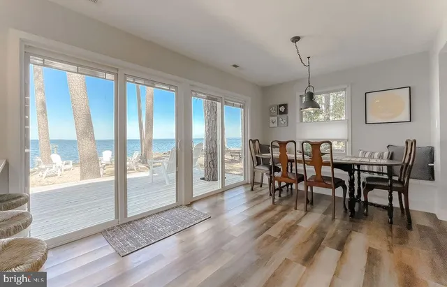 a view of a dining room with furniture window and wooden floor