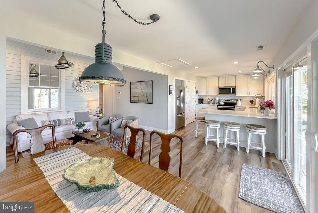 18375 River Road Tall Timbers, MD 20690 - Photo 20 of 61 a living room with furniture kitchen view and a wooden floor