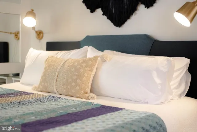 a bedroom with a bed and a lamp