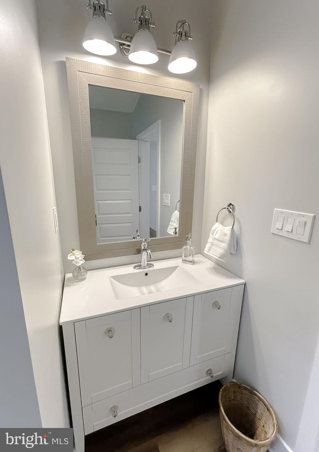 18375 River Road Tall Timbers, MD 20690 - Photo 40 of 61 a bathroom with a sink and a mirror
