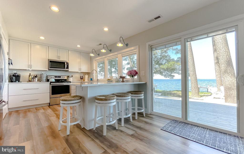 18375 River Road Tall Timbers, MD 20690 - Photo 10 of 61 a kitchen with stainless steel appliances granite countertop a stove and a refrigerator