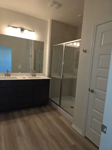 a bathroom with a double vanity sink and mirror