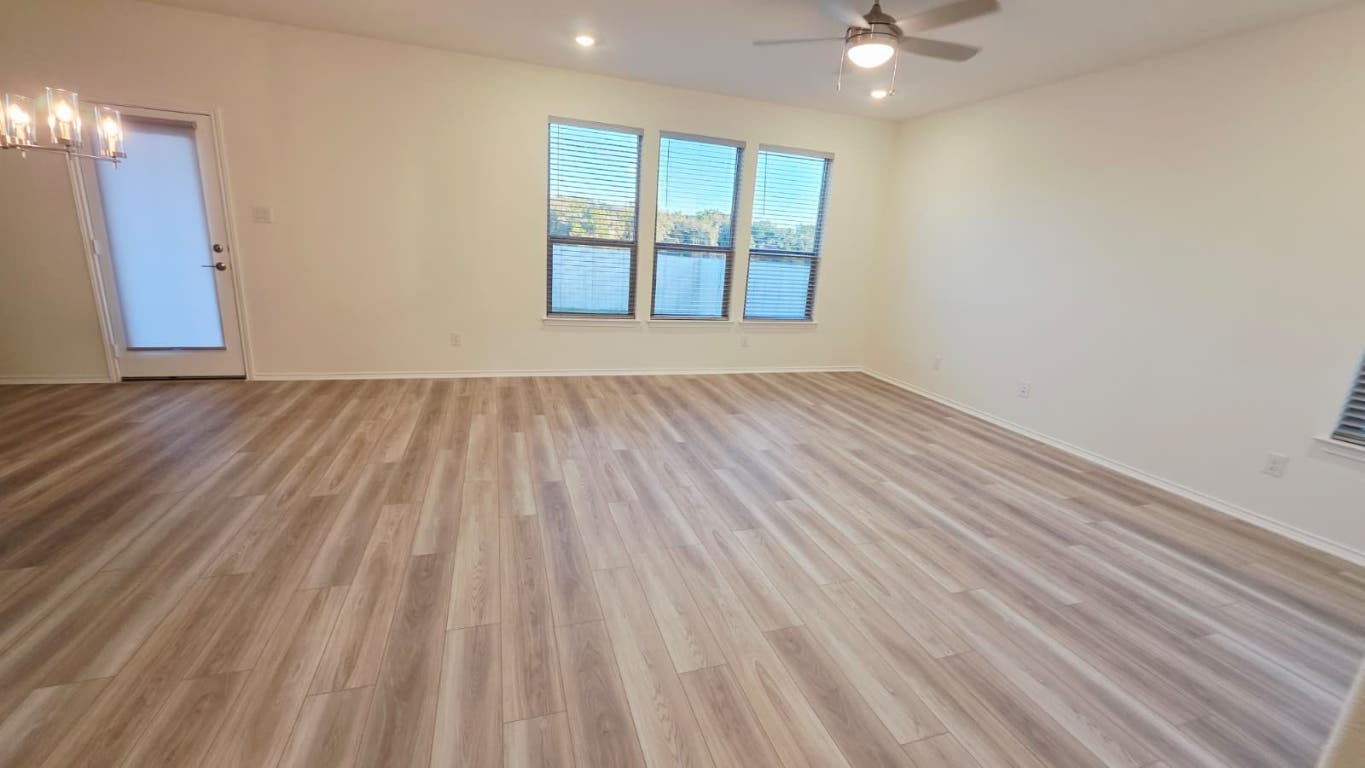 1609 Red Berry Pass Georgetown, TX 78628 - Photo 22 of 29 wooden floor in an empty room with a window