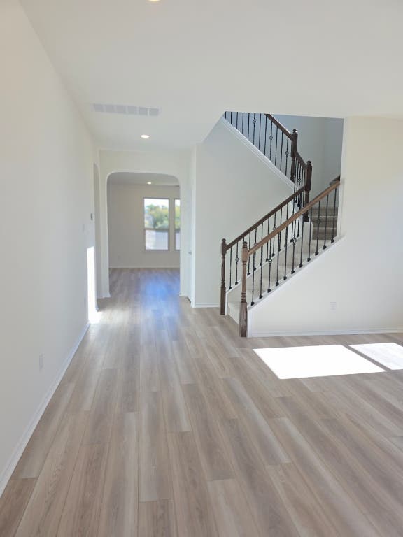 1609 Red Berry Pass Georgetown, TX 78628 - Photo 7 of 29 a view of a hallway with wooden floor