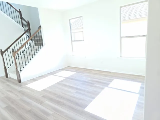 a view of a room with wooden floor