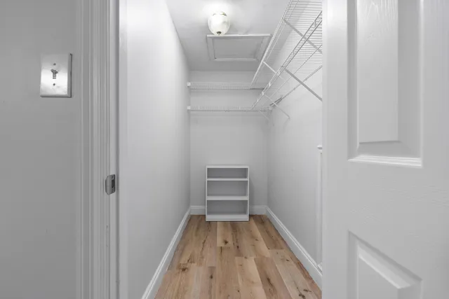 a view of a room with wooden floor