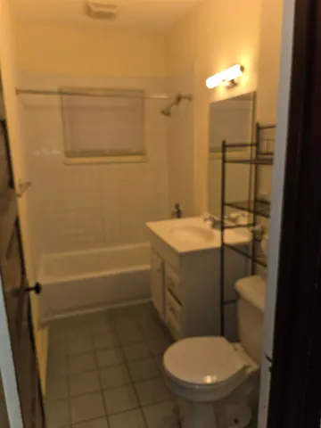 a bathroom with a toilet a sink and shower