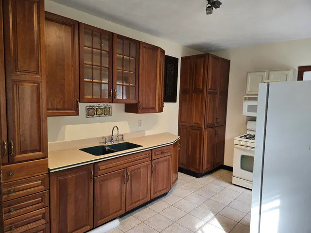 a kitchen with stainless steel appliances granite countertop a refrigerator and a sink