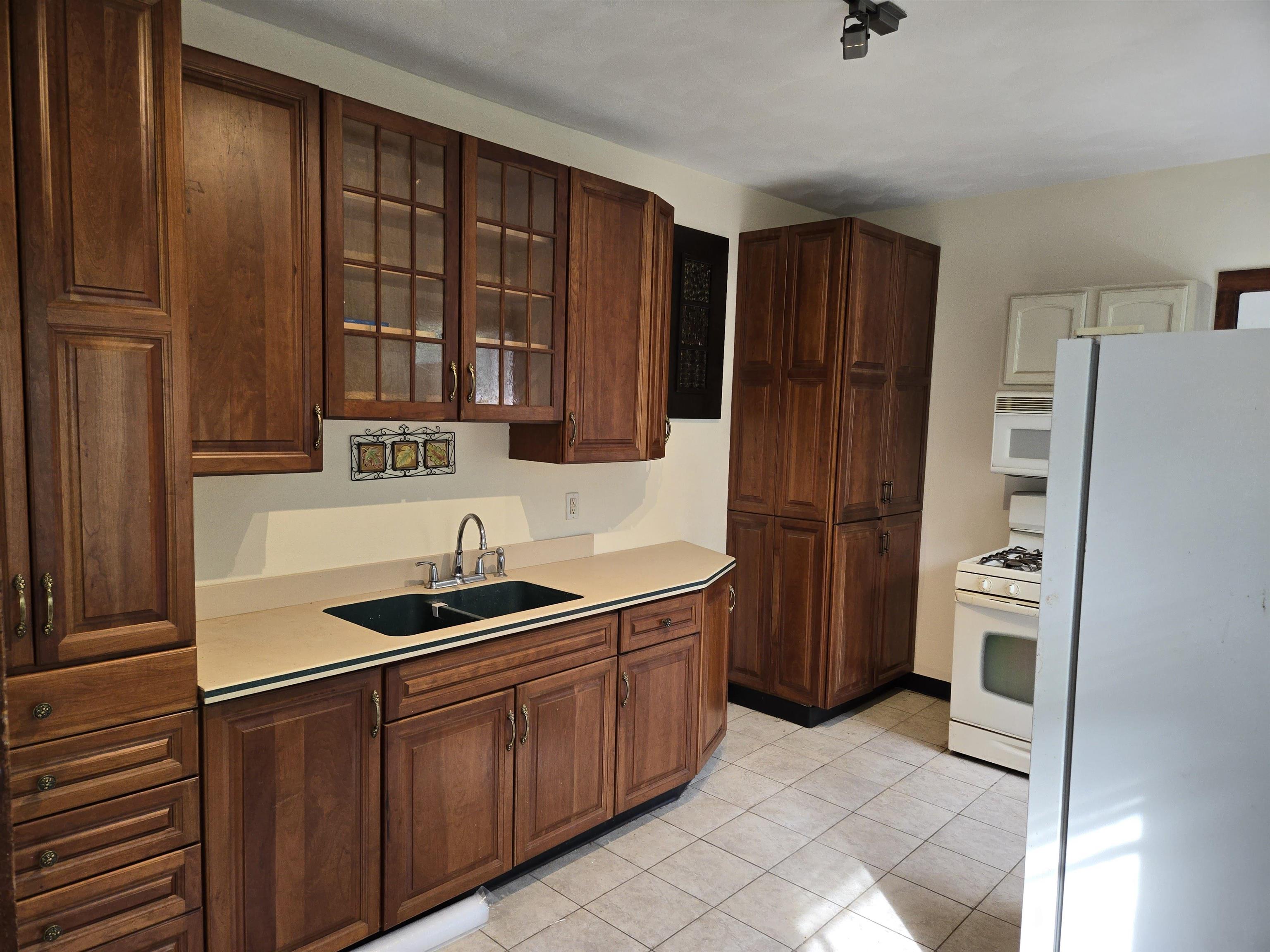 412-414 May Street Rockford, IL 61104 - Photo 3 of 11 a kitchen with stainless steel appliances granite countertop a refrigerator and a sink