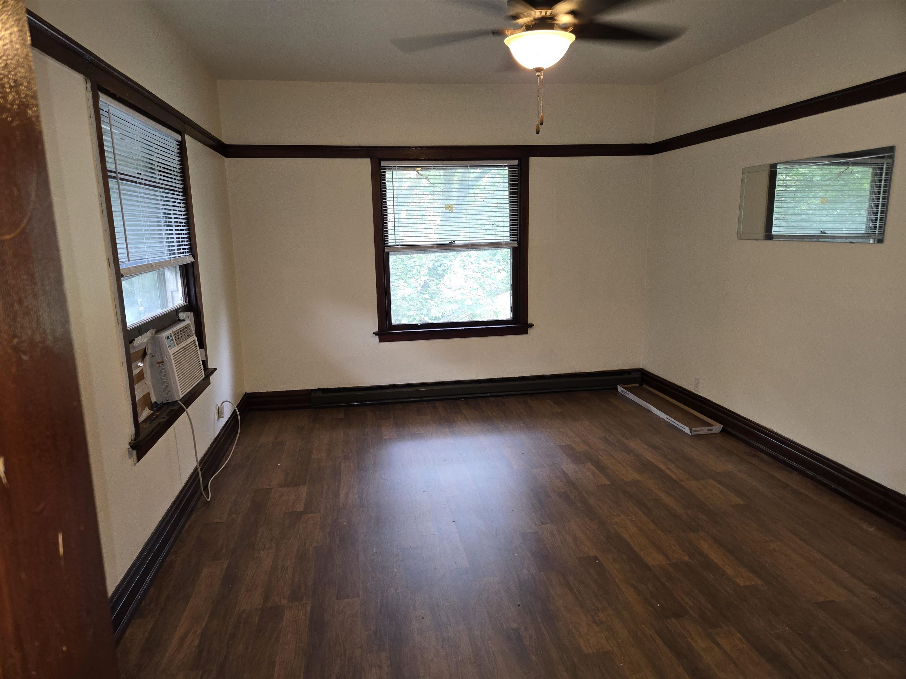 412-414 May Street Rockford, IL 61104 - Photo 6 of 11 a view of an empty room with wooden floor and a window