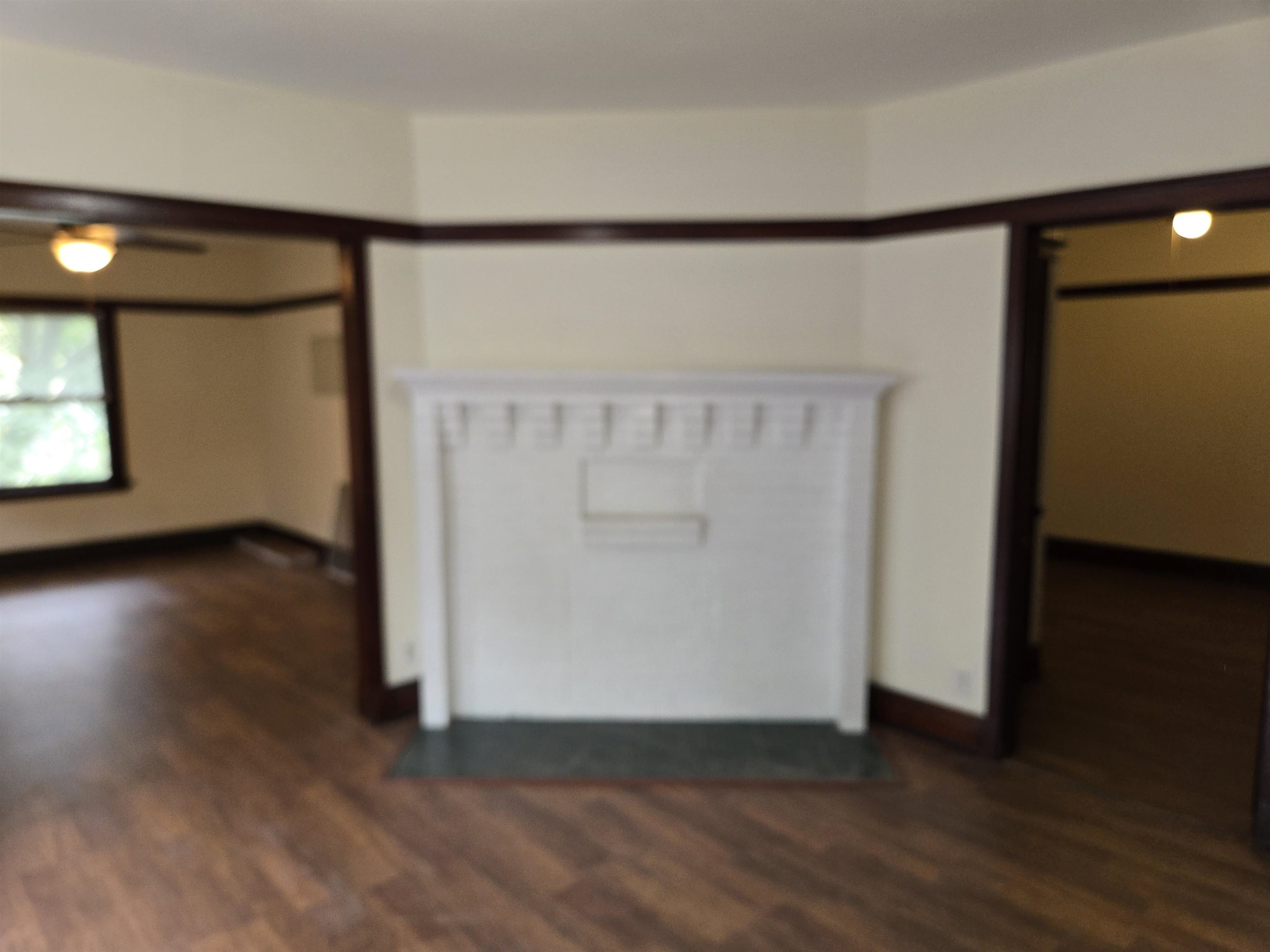 412-414 May Street Rockford, IL 61104 - Photo 8 of 11 an empty room with wooden floor and windows