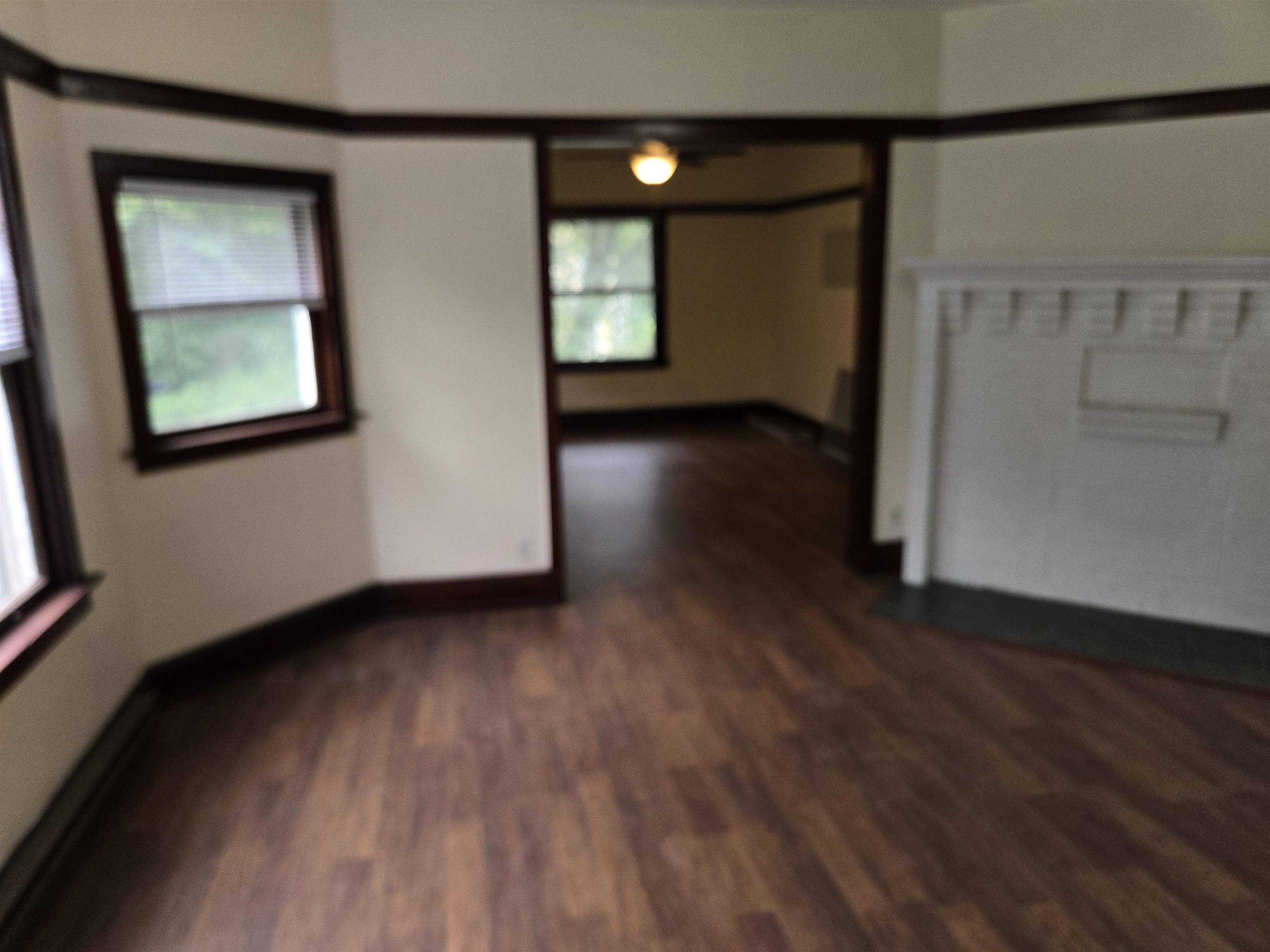 412-414 May Street Rockford, IL 61104 - Photo 9 of 11 an empty room with wooden floor and windows