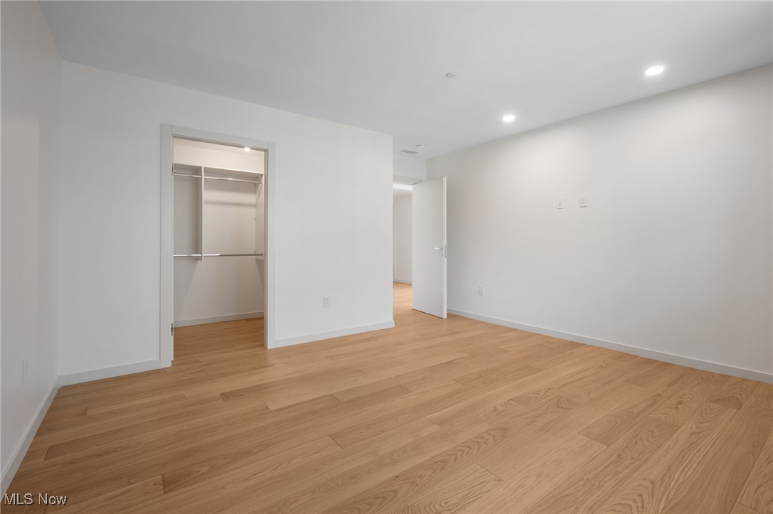 22700 Lake Road, Unit 306 Rocky River, OH 44116 - Photo 25 of 28 Unfurnished bedroom with light wood-type flooring, recessed lighting, and a walk in closet