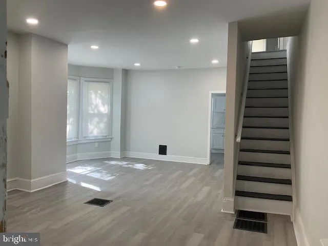 a view of wooden floor and windows in a room