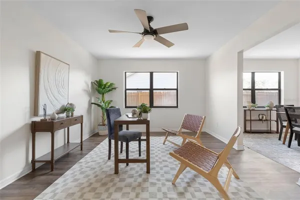 a workspace with wooden floor and a window