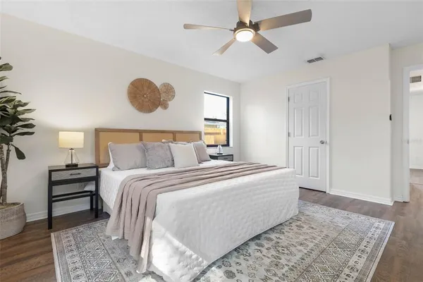 a bedroom with a bed and a chandelier