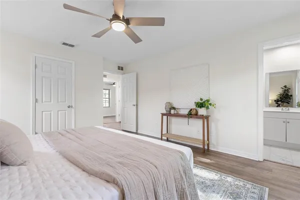 a bedroom with a bed and a chandelier fan