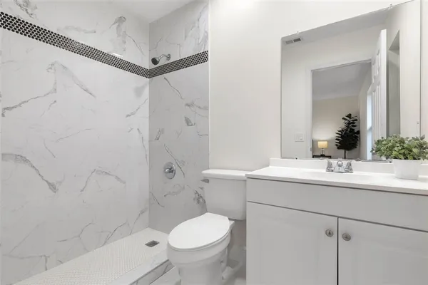 a bathroom with a sink toilet and shower