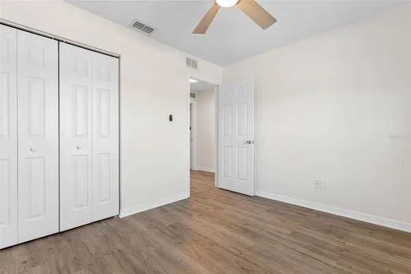 a view of an empty room with wooden floor