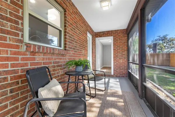 a view of balcony with two chairs and a potted plant