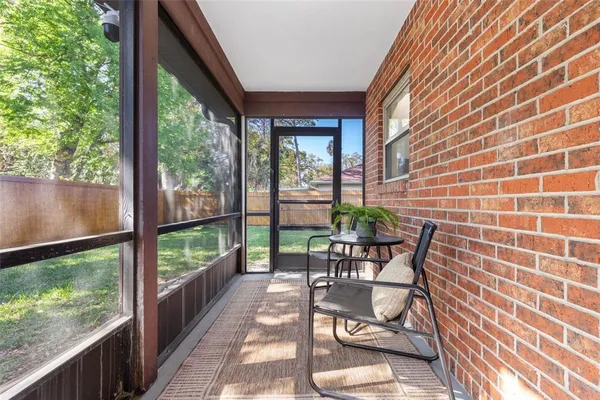 a view of a patio with a table chairs and backyard