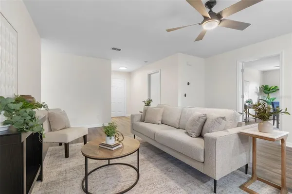 a living room with furniture and a potted plant