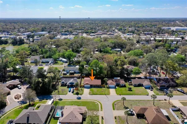 an aerial view of a houses with yard swimming pool and ocean view