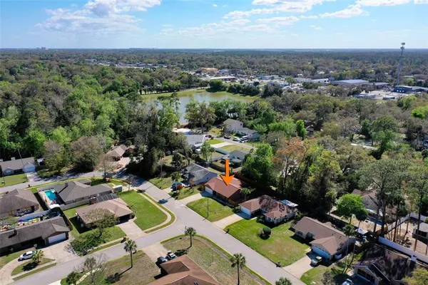 an aerial view of a houses with a swimming pool