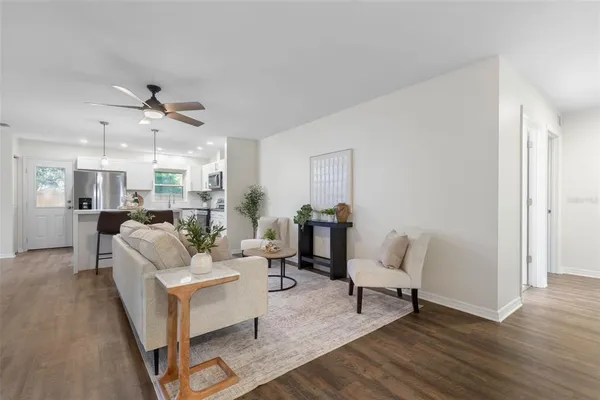 a living room with furniture and a chandelier