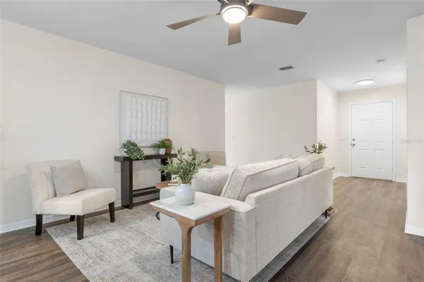 a living room with furniture and a potted plant