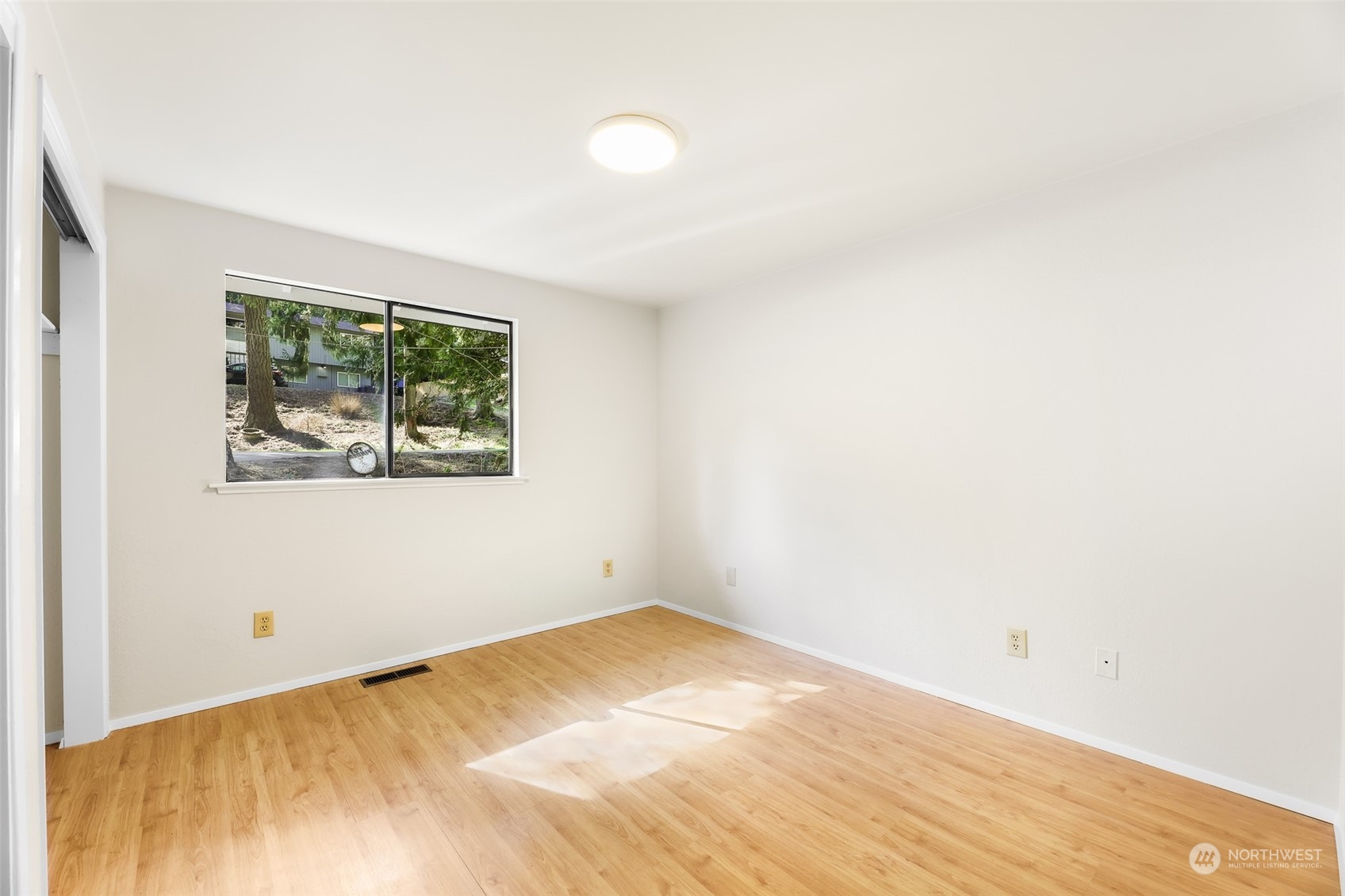 6921 Spada Road Snohomish, WA 98290 - Photo 16 of 40 a view of an empty room with wooden floor and a window