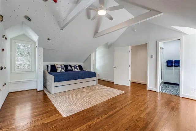 a bathroom with a granite countertop toilet sink and mirror
