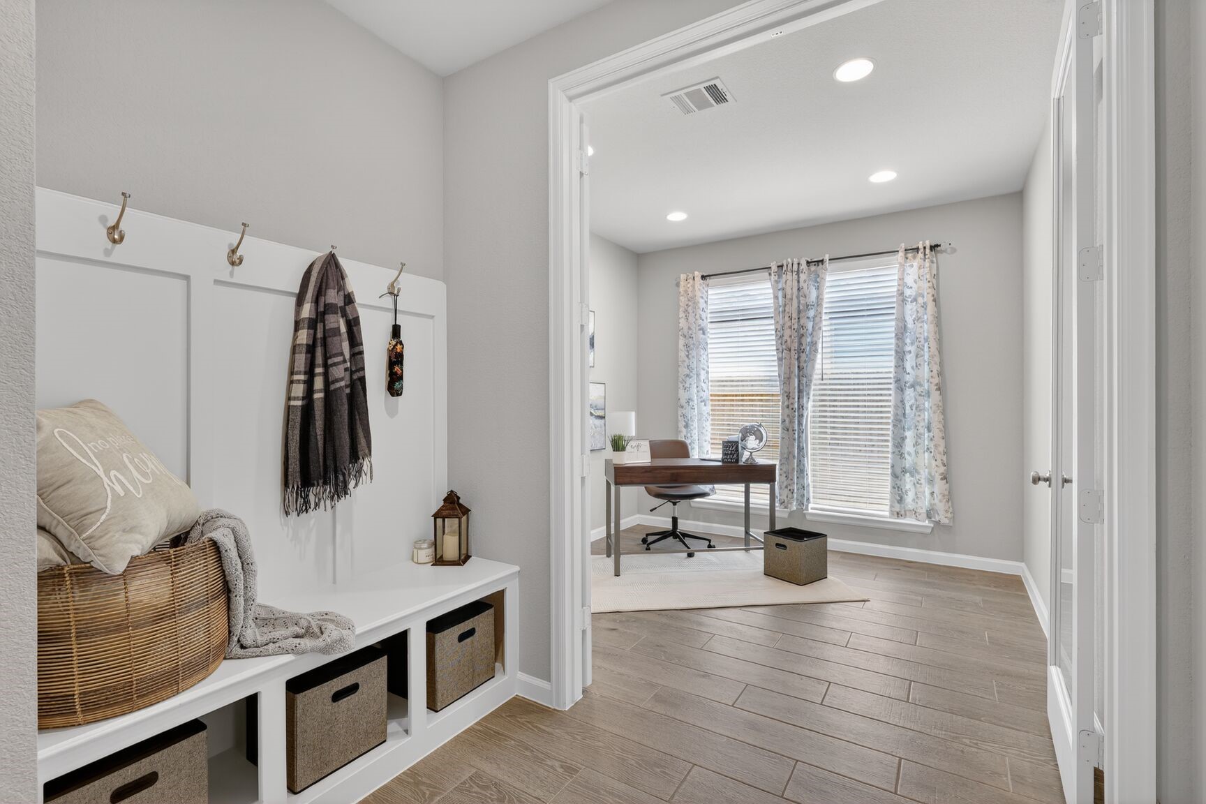 The perfect transition from outside world to home. This sleek mudroom off the garage entry offers dedicated storage for bags, coats, and shoes, ensuring everything has its place.