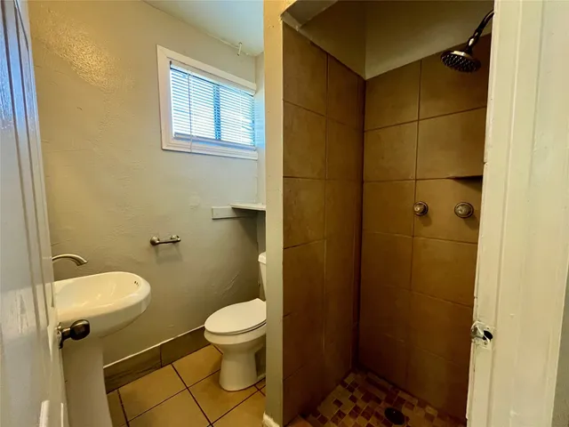 a bathroom with a toilet and a shower