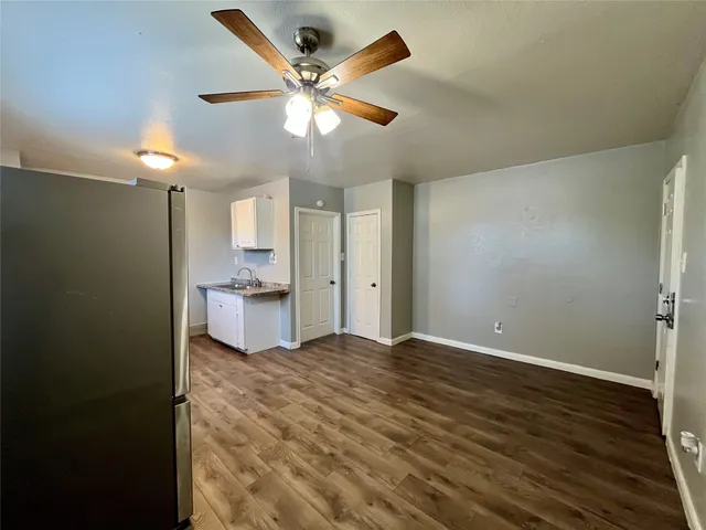 a view of a kitchen with a sink and a refrigerator