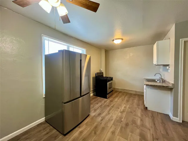 a kitchen with stainless steel appliances a refrigerator and a sink
